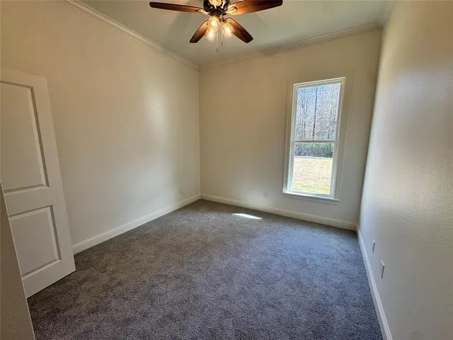 an empty room with wooden floor and entrance