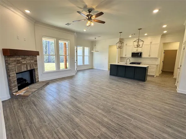 a view of a livingroom with a kitchen and a chandelier