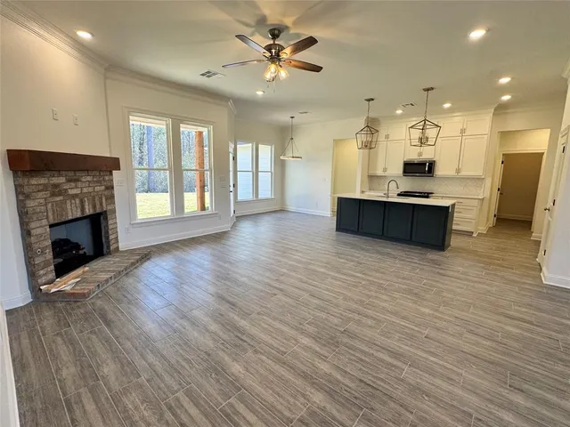 a view of a livingroom with a kitchen and a chandelier