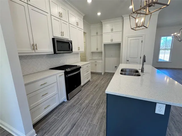 a large living room with stainless steel appliances granite countertop a couch and a fireplace