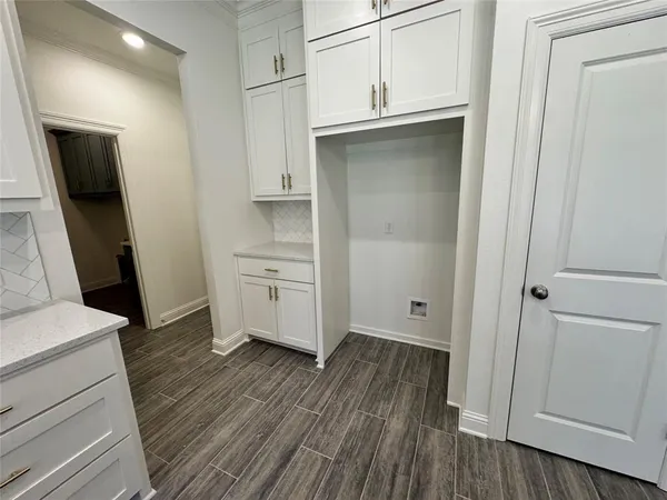 a large hall with wooden floor and a large mirror
