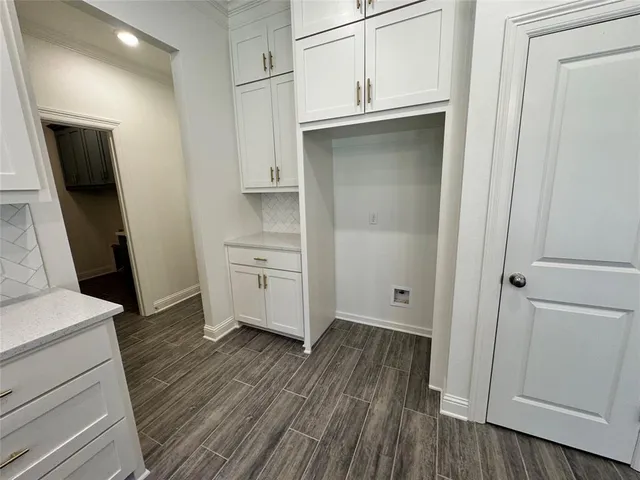 a large hall with wooden floor and a large mirror