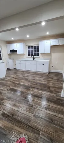 a kitchen with a sink stainless steel appliances and cabinets