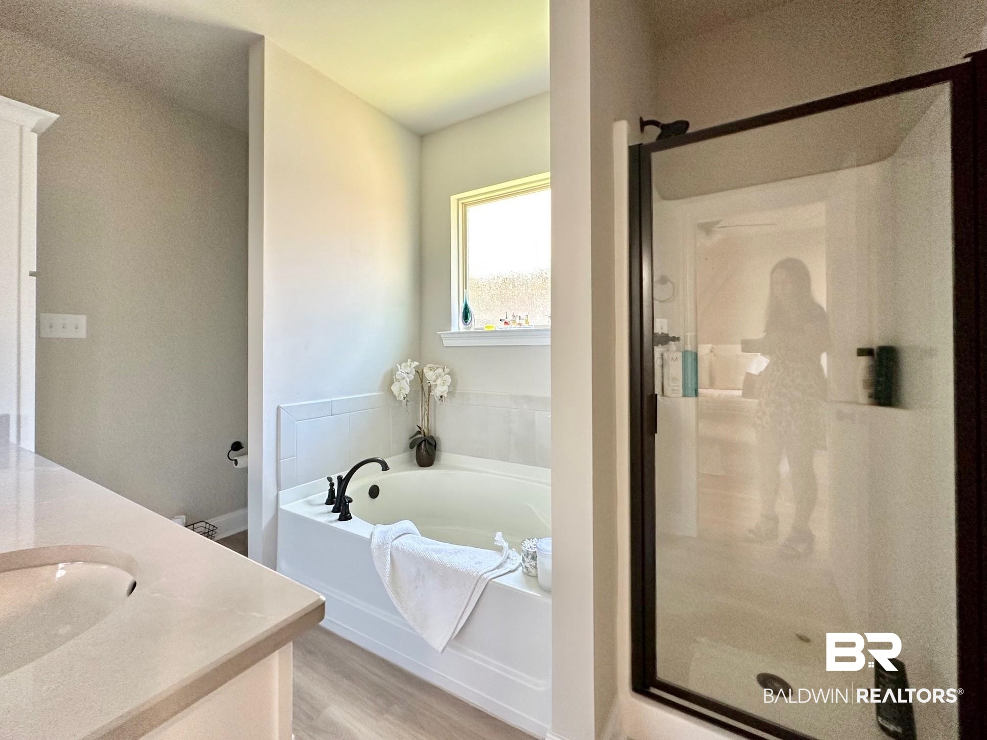 1009 Ruisseau Drive Foley, AL 36535 - Photo 38 of 55 Bathroom with vanity, wood-type flooring, and separate shower and tub