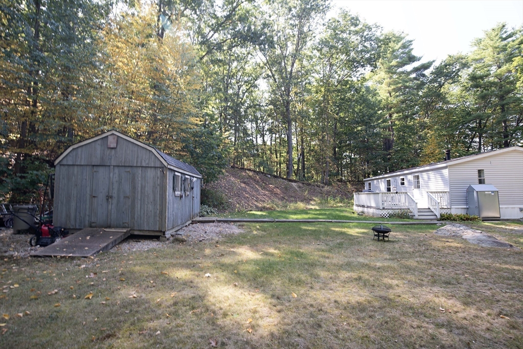 157 Scotland Road Newbury, MA 01951 - Photo 29 of 34 a view of a barn in front of a yard with wooden fence and plants