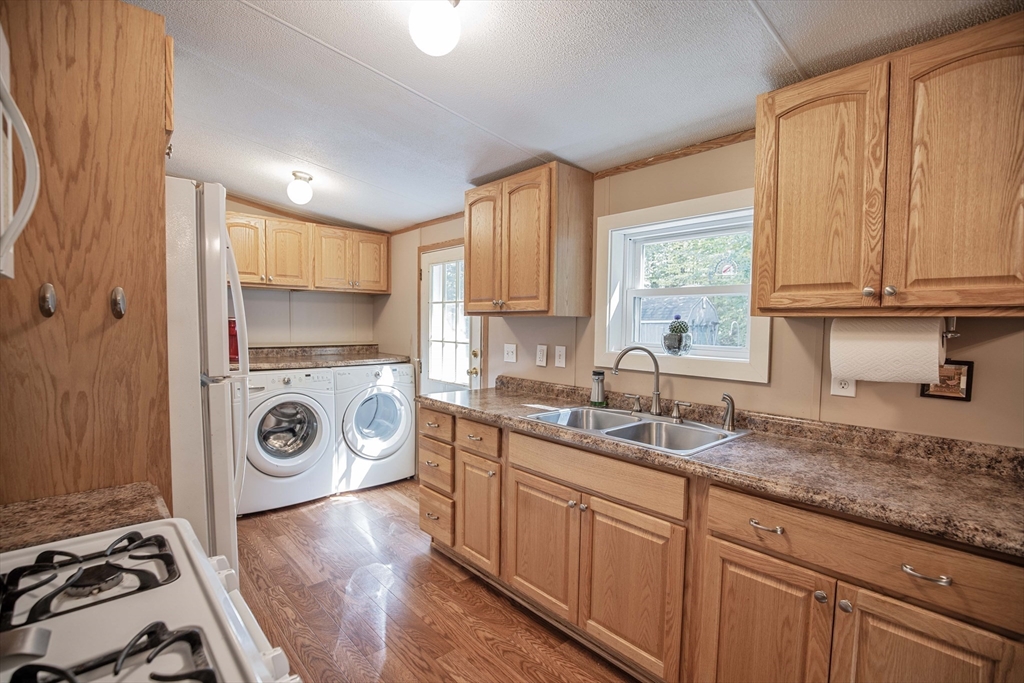 157 Scotland Road Newbury, MA 01951 - Photo 10 of 34 a kitchen with a sink a stove and cabinets