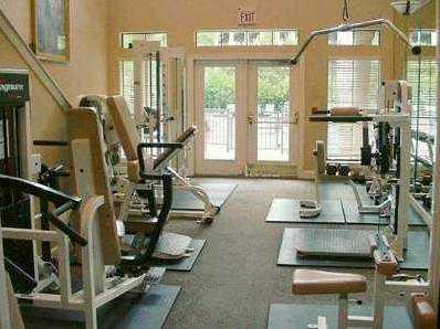 3777 Peachtree Road Northeast, Unit 1035 Atlanta, GA 30319 - Photo 6 of 7 a room with gym equipment and large mirror