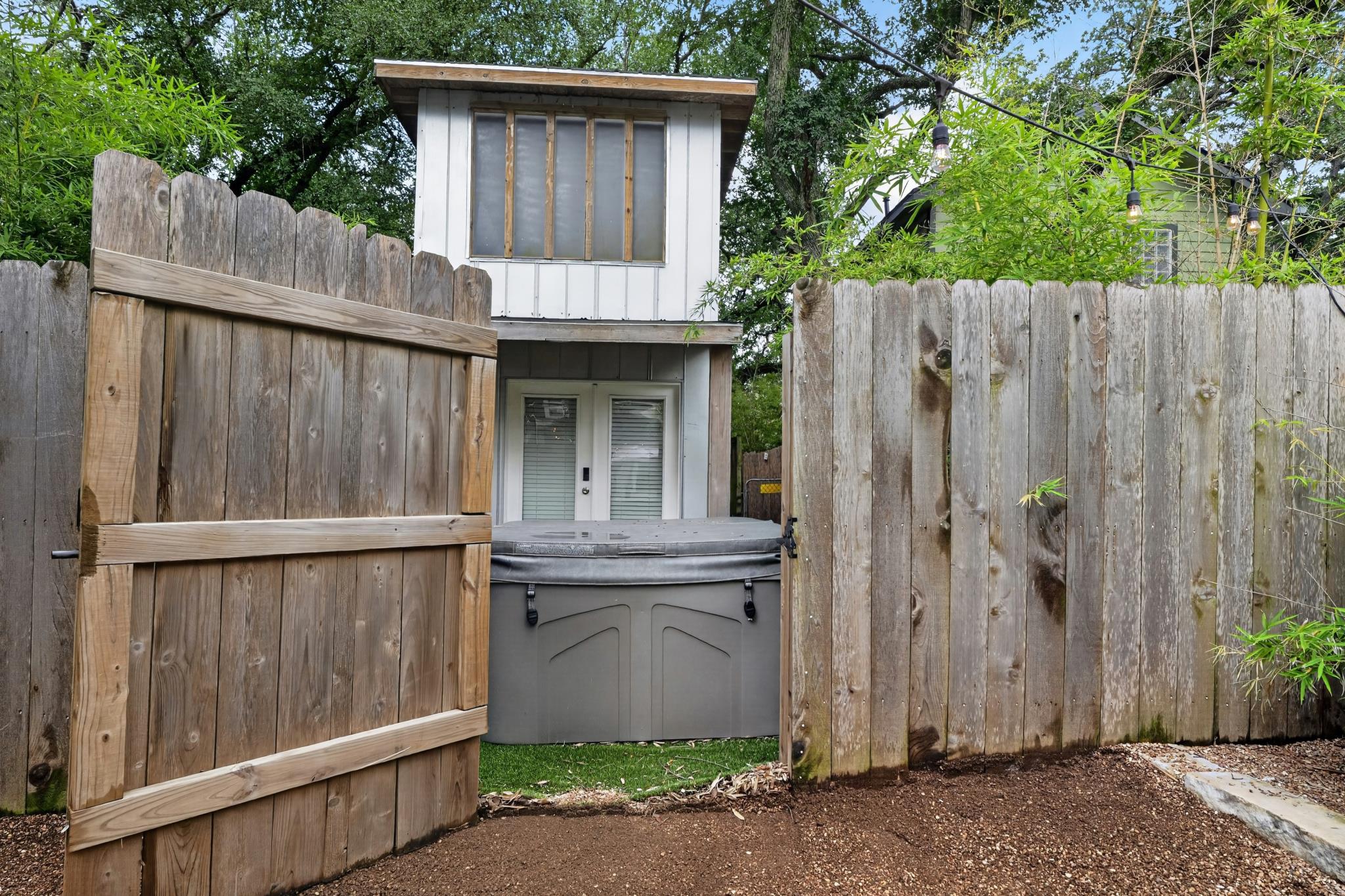 307 East 35th Street, Unit A Austin, TX 78705 - Photo 12 of 40 A secluded outdoor spa area with a tall wooden fence for ultimate privacy.