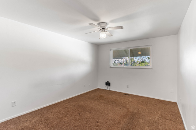 728 400 East Orem, UT 84097 - Photo 24 of 30 Carpeted room featuring a ceiling fan with light fixture and a double-pane window