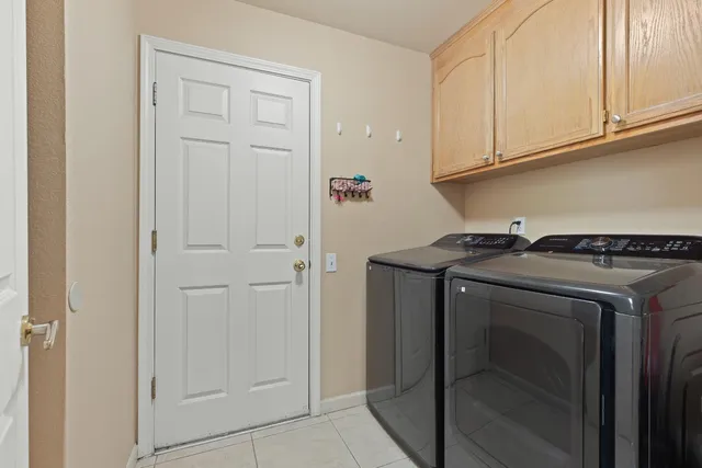 a patio with wooden floor a yard a table and chairs