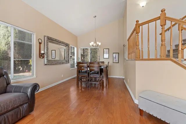 a dining room with furniture window and wooden floor