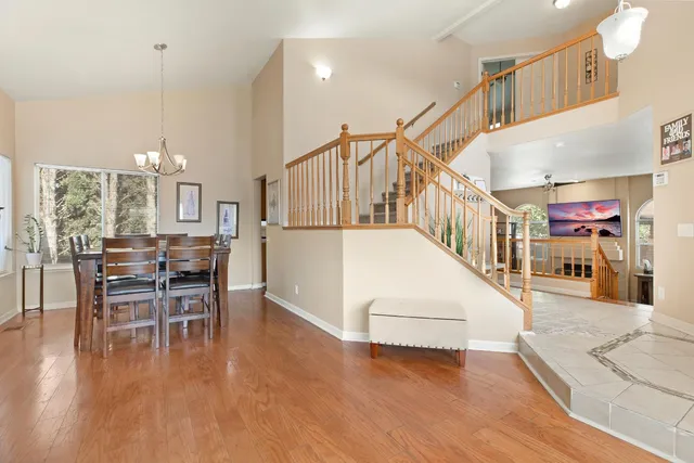 a view of a livingroom with furniture wooden floor and a kitchen