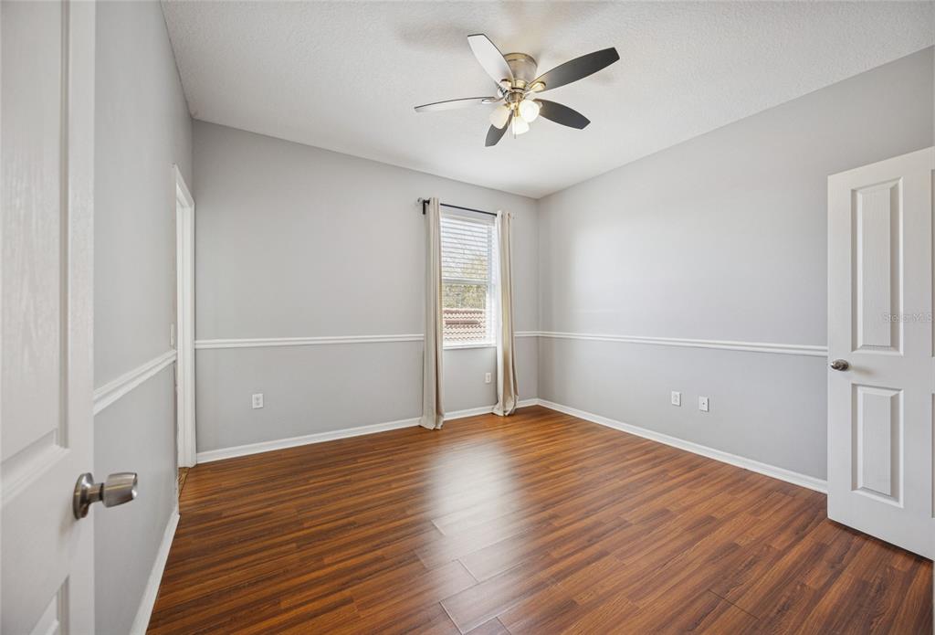 3140 Riachuelo Lane Kissimmee, FL 34744 - Photo 15 of 24 an empty room with wooden floor and windows