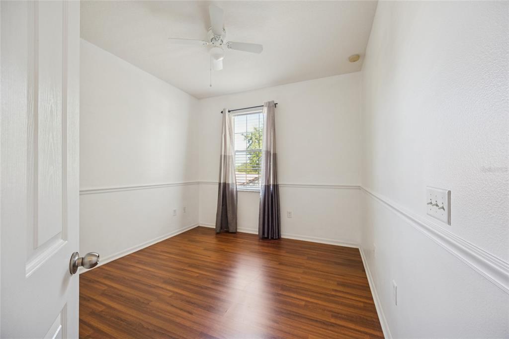 3140 Riachuelo Lane Kissimmee, FL 34744 - Photo 17 of 24 a view of a room with wooden floor and white walls