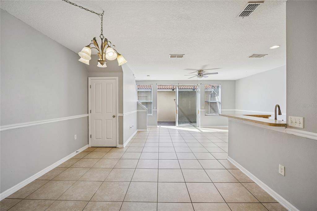 3140 Riachuelo Lane Kissimmee, FL 34744 - Photo 6 of 24 a view of a kitchen with a sink and chandelier