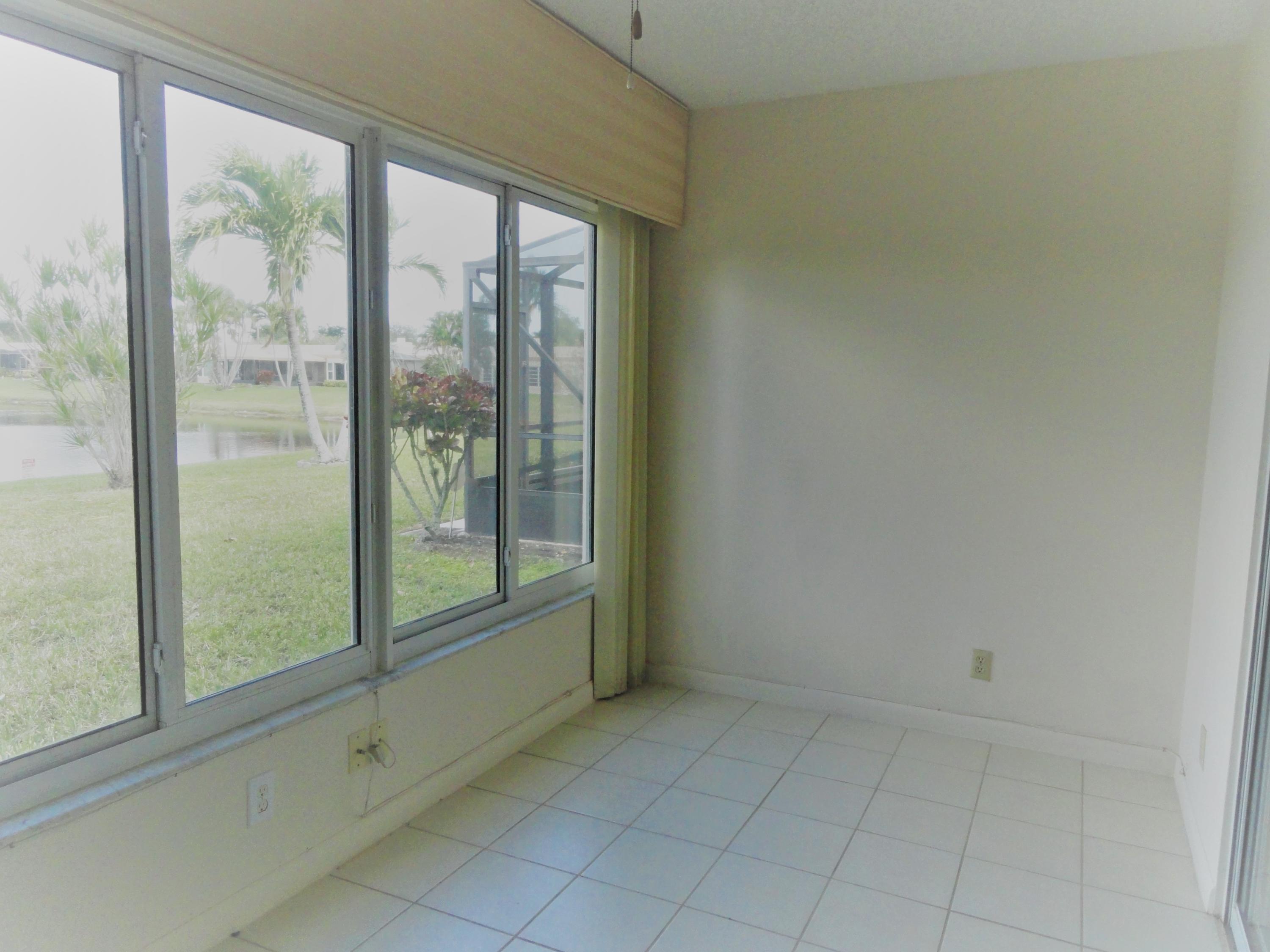 9111 Tracy Court, Unit 2 Boca Raton, FL 33496 - Photo 13 of 25 Enclosed Patio with Lake View