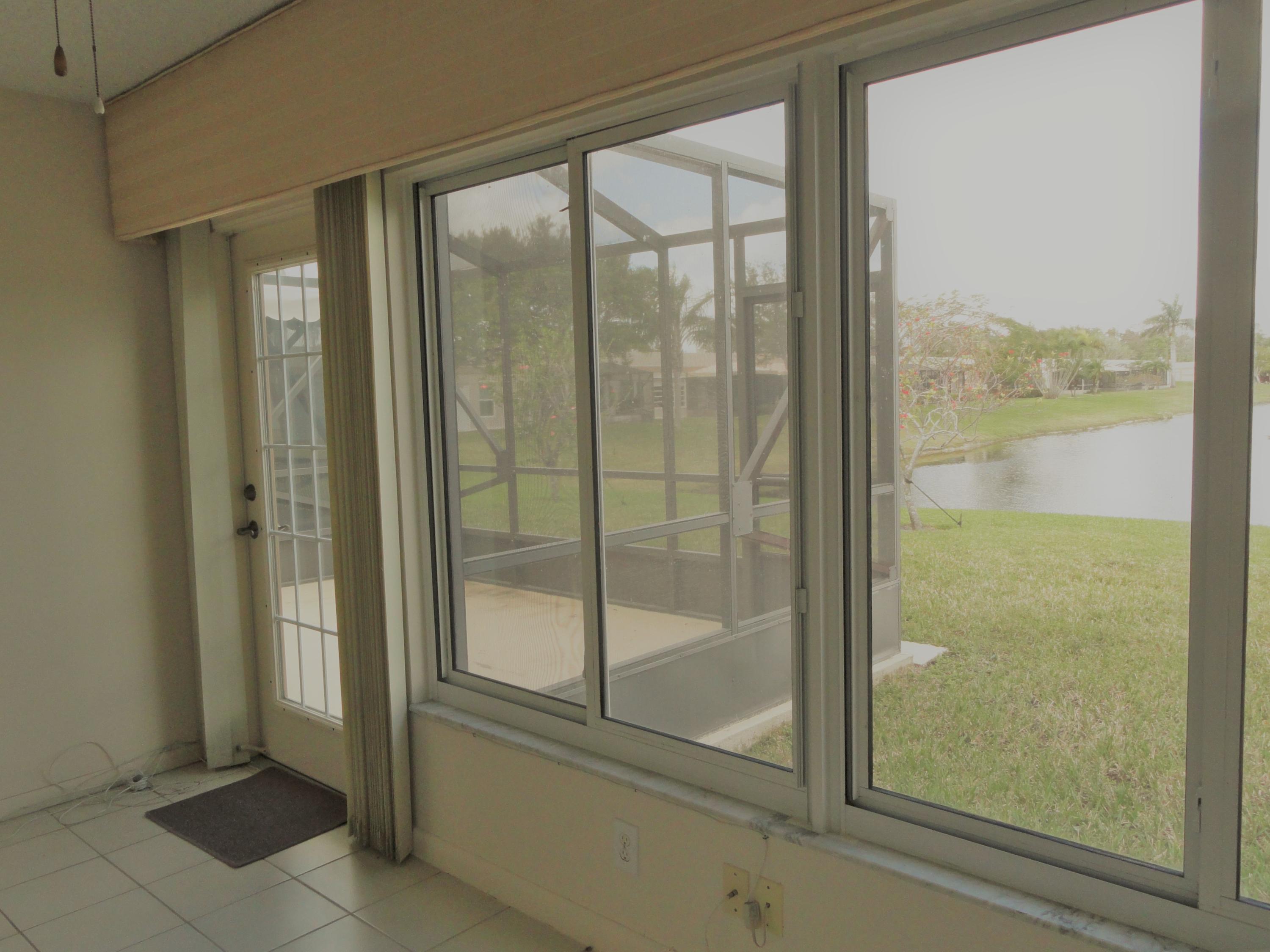 9111 Tracy Court, Unit 2 Boca Raton, FL 33496 - Photo 14 of 25 Enclosed Patio with Entry to Large Scree
