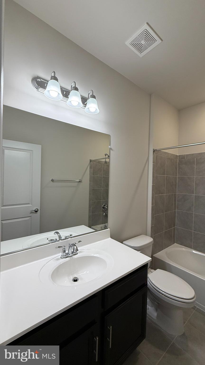1949 Greenbriar Hall Road Dumfries, VA 22026 - Photo 17 of 26 a bathroom with a sink vanity mirror and toilet