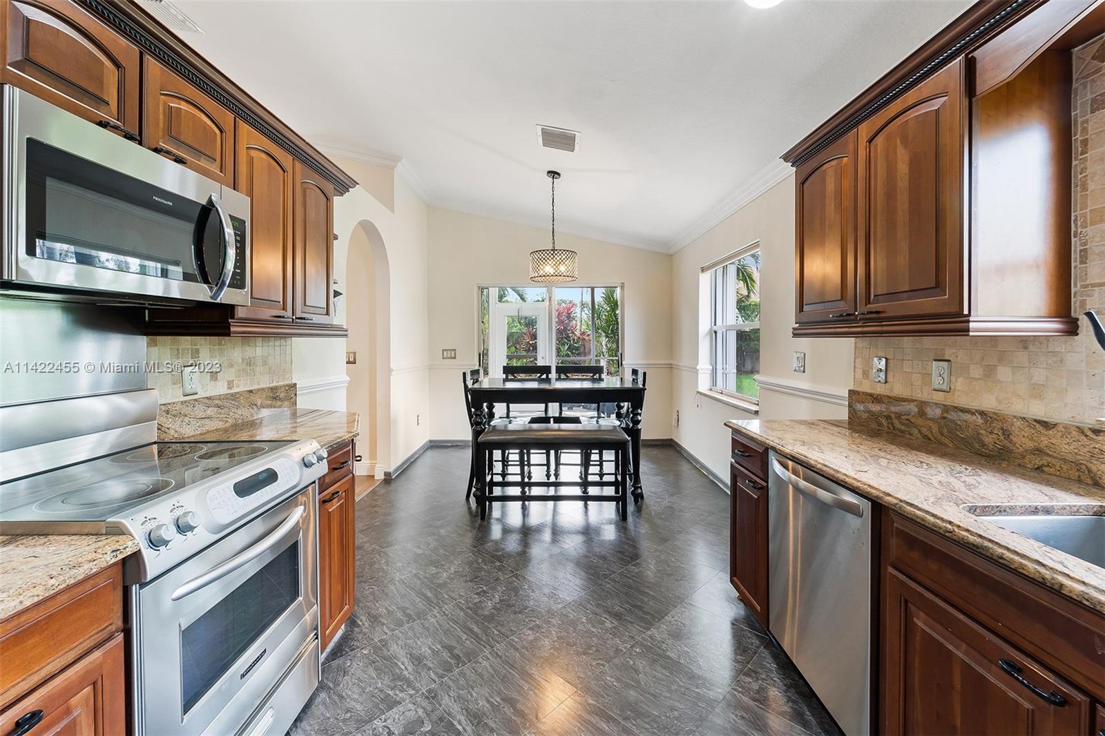 22699 Royal Crown Terrace East Boca Raton, FL 33433 - Photo 16 of 36 a kitchen with a stove a sink and a microwave