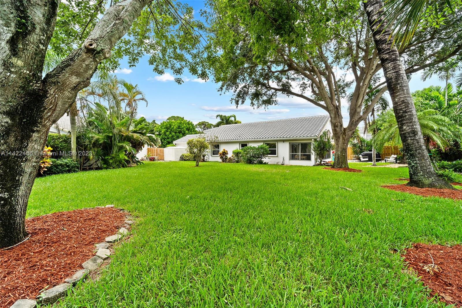 22699 Royal Crown Terrace East Boca Raton, FL 33433 - Photo 2 of 36 a front view of a house with garden