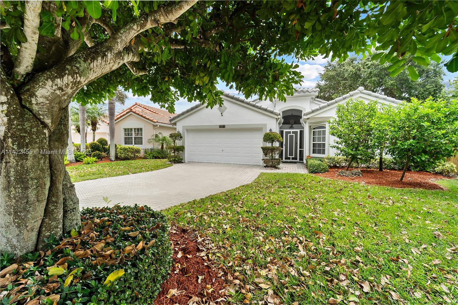 22699 Royal Crown Terrace East Boca Raton, FL 33433 - Photo 24 of 36 a front view of a house with a garden
