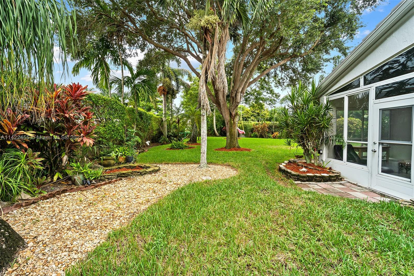 22699 Royal Crown Terrace East Boca Raton, FL 33433 - Photo 34 of 36 a front view of a house with a yard table and chairs