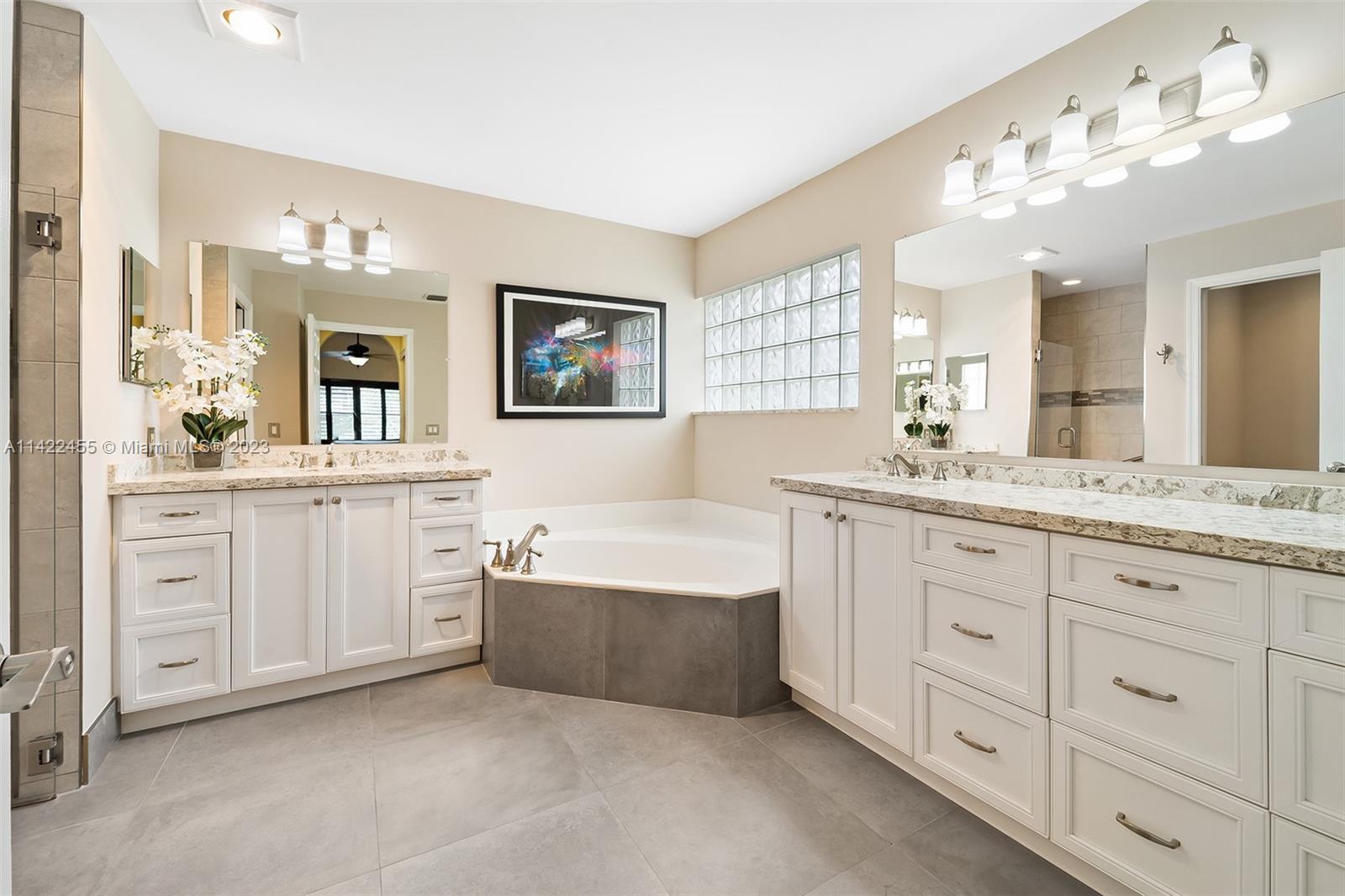 22699 Royal Crown Terrace East Boca Raton, FL 33433 - Photo 10 of 36 a spacious bathroom with a double vanity sink mirror and bathtub