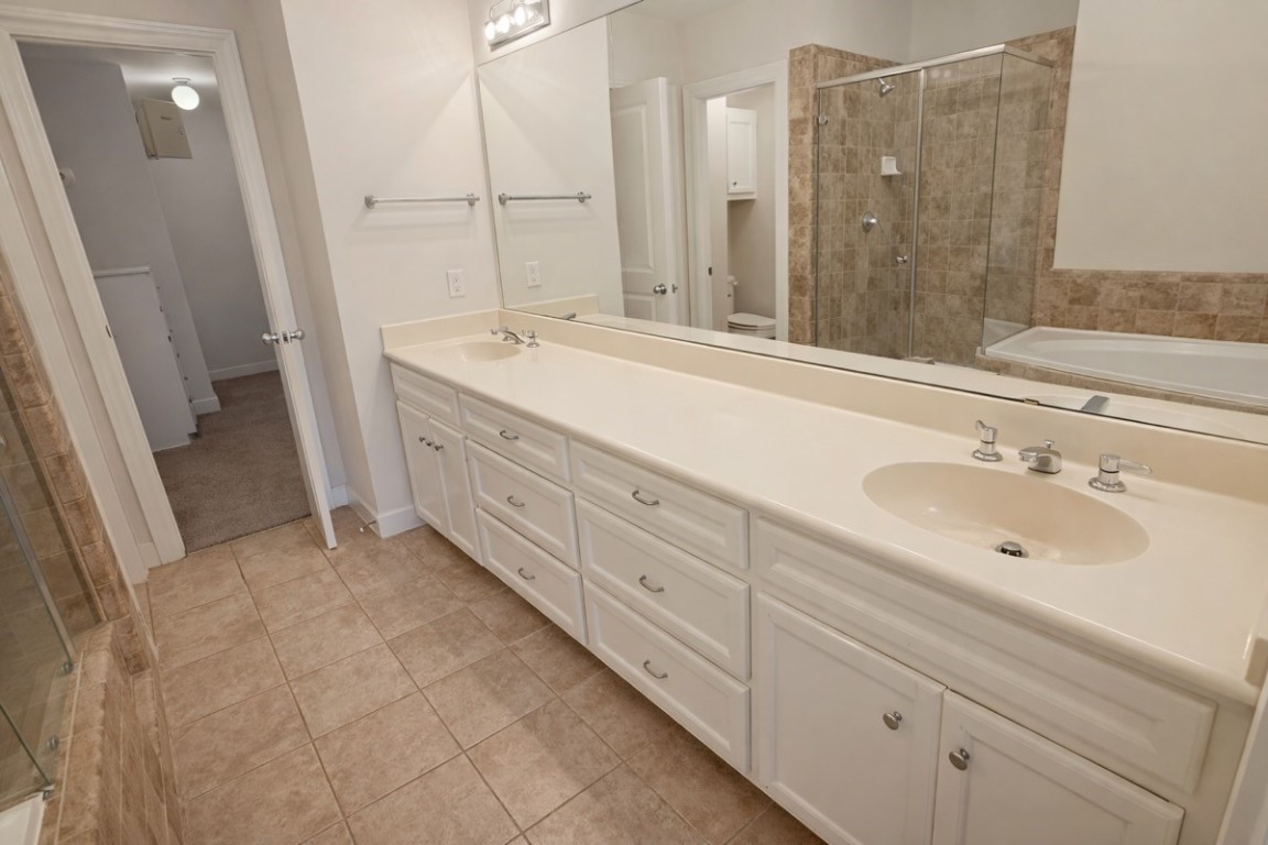 2710 Hullsmith Drive, Unit 803 Houston, TX 77063 - Photo 11 of 21 a bathroom with double sink and a mirror