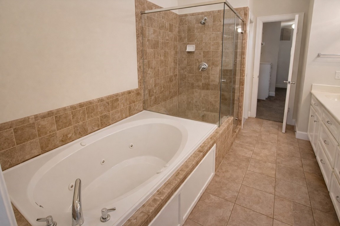 2710 Hullsmith Drive, Unit 803 Houston, TX 77063 - Photo 13 of 21 a bathroom with a bathtub and a shower