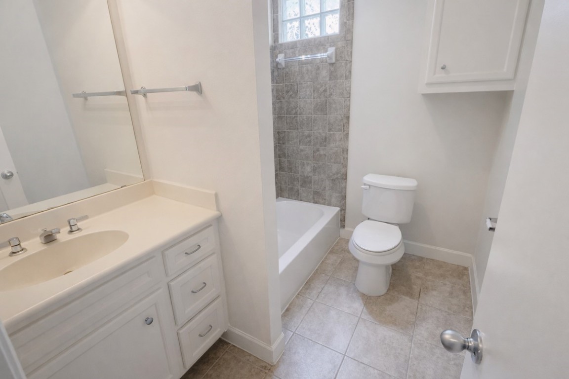 2710 Hullsmith Drive, Unit 803 Houston, TX 77063 - Photo 16 of 21 a bathroom with a toilet sink and mirror