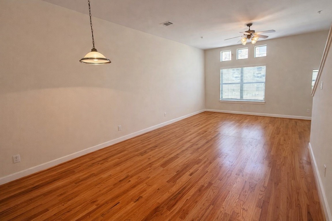 2710 Hullsmith Drive, Unit 803 Houston, TX 77063 - Photo 2 of 21 wooden floor in an empty room with a window