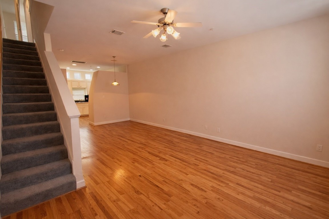 2710 Hullsmith Drive, Unit 803 Houston, TX 77063 - Photo 3 of 21 wooden floor in an empty room with a window
