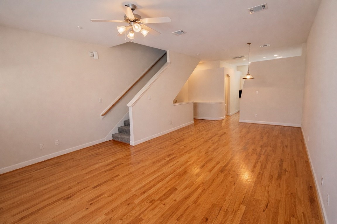 2710 Hullsmith Drive, Unit 803 Houston, TX 77063 - Photo 4 of 21 wooden floor in an empty room with a window