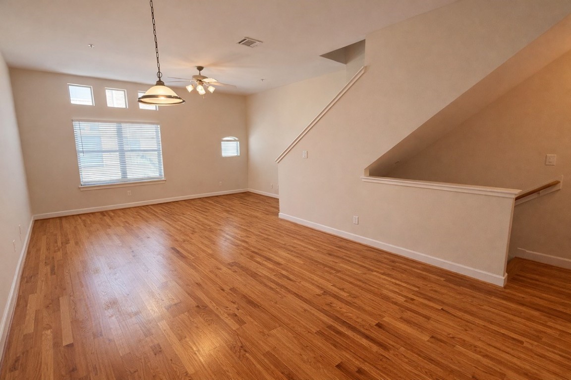 2710 Hullsmith Drive, Unit 803 Houston, TX 77063 - Photo 5 of 21 a view of an empty room with wooden floor and a window