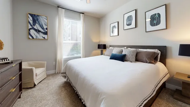 a bedroom with bed and painting on the wall