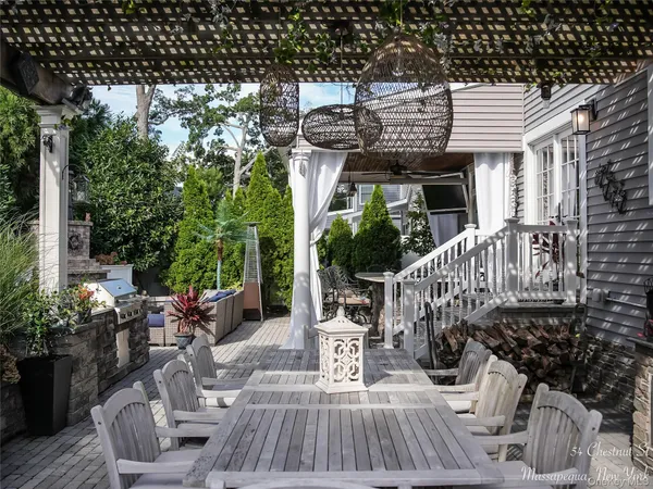 a view of a patio with couches table and chairs and potted plants