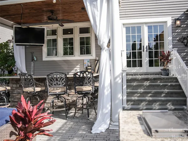 a front view of a house with outdoor seating