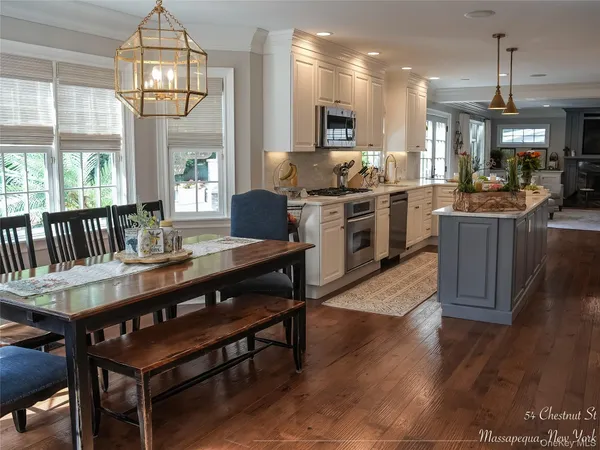 a kitchen with a dining table chairs and stove