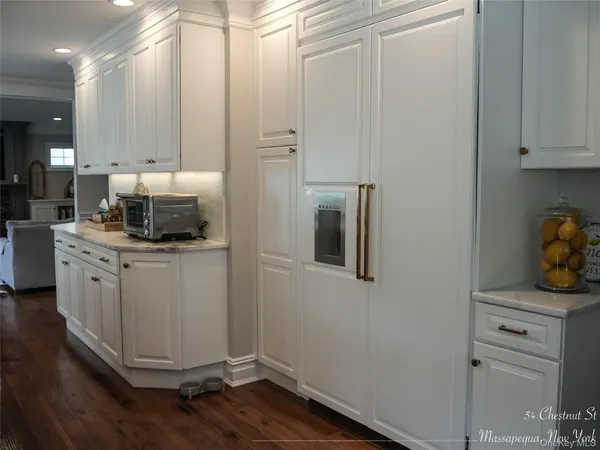 a kitchen with a refrigerator and cabinets