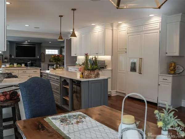 a kitchen with stainless steel appliances kitchen island granite countertop a sink stove and cabinets