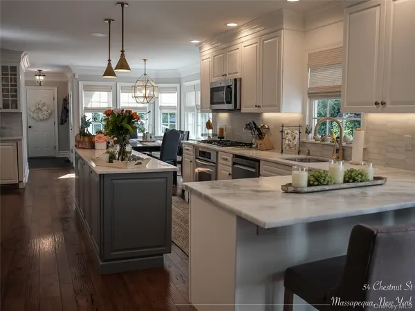 a kitchen with sink cabinets and wooden floor