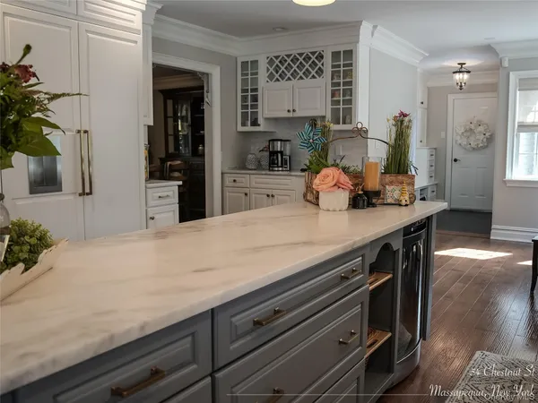 a kitchen with a counter space a sink and potted plant