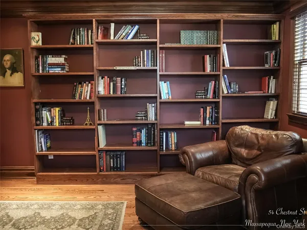 a living room with furniture and a book shelf