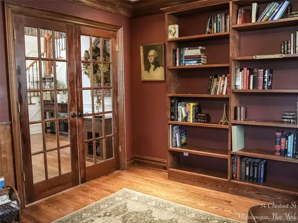 a room with bookshelf and a window