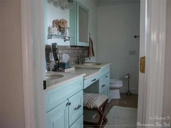 a bathroom with a toilet a sink and a mirror