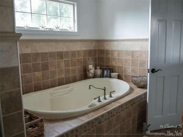 a bath tub sitting in a bathroom next to a window