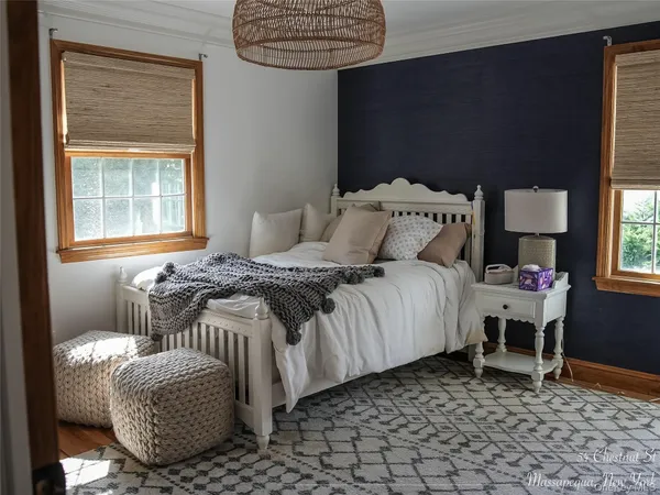 a bed sitting in a bedroom next to a window