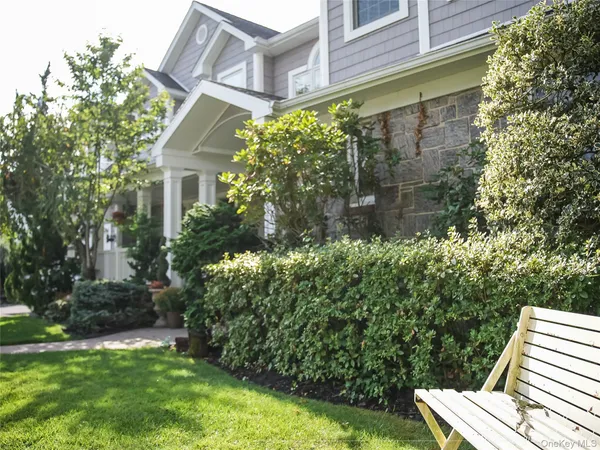 a view of backyard with plants and outdoor seating