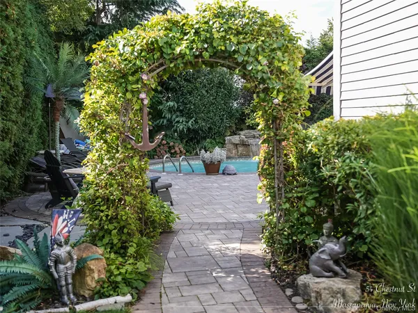 a view of a garden with large trees