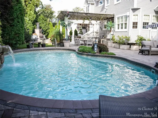 swimming pool view with a outdoor seating